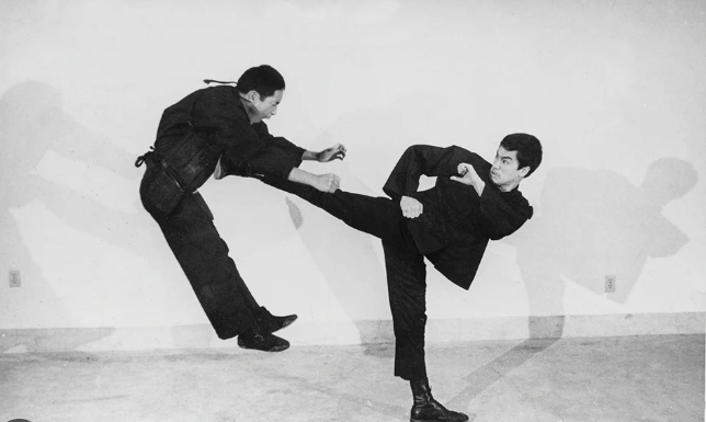 Bruce Lee executing a perfect side kick.
